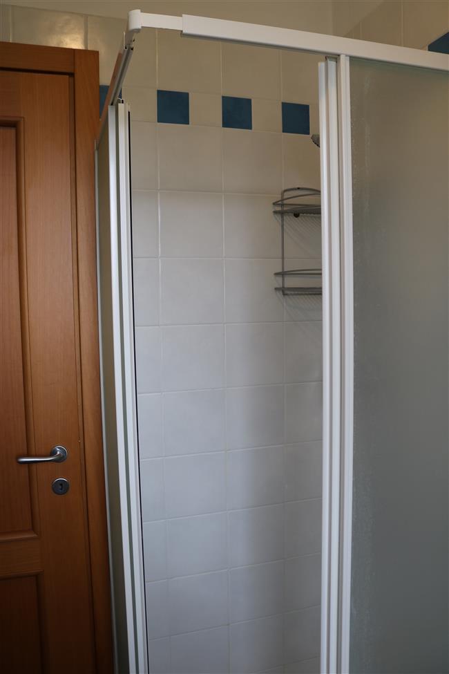 bathroom with shower and washing machine